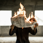 man burning a newspaper