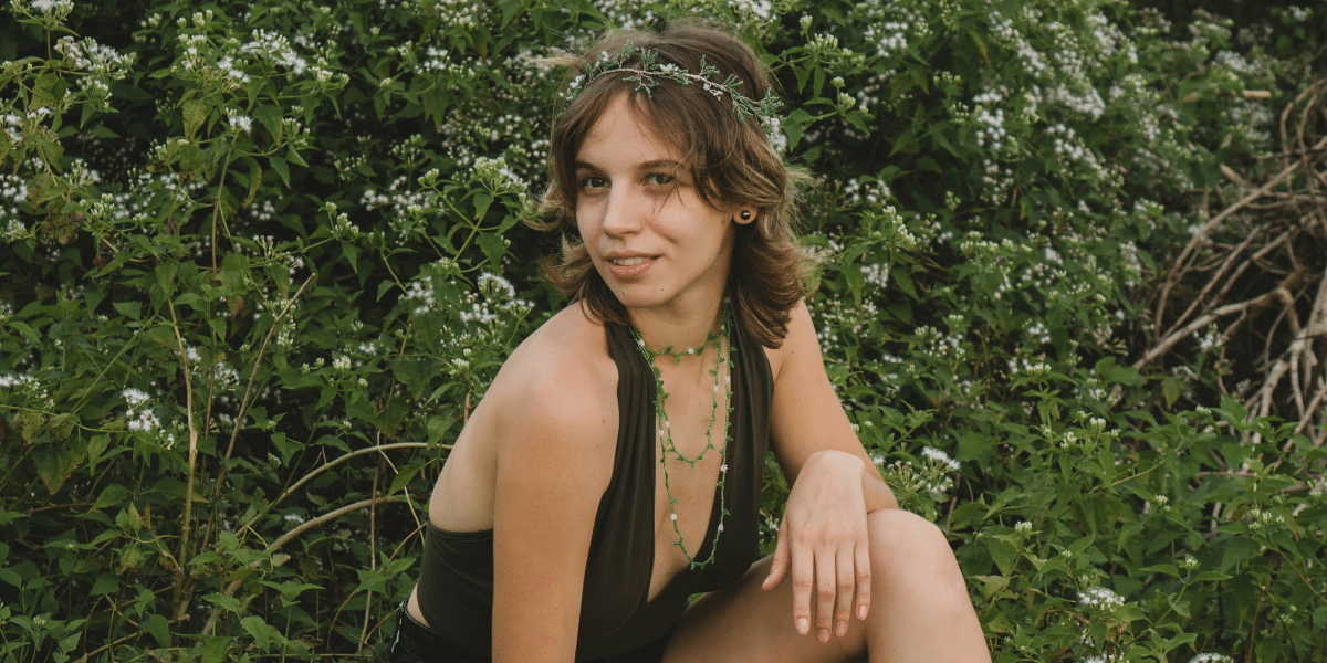 woman sitting with a nature-ish background